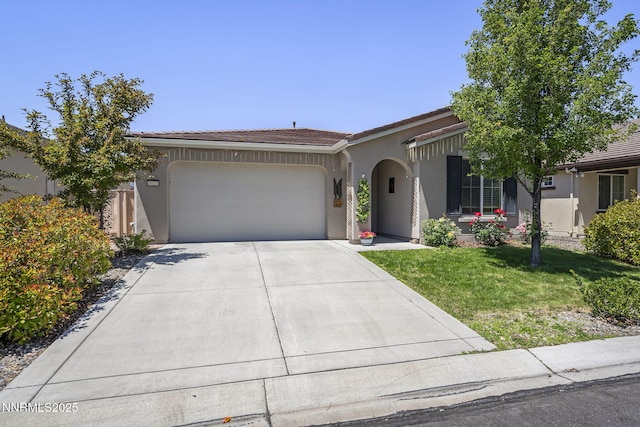 10125 Mesa Cortona Dr, Reno, NV 89521 - view of front of property featuring a garage, stucco siding, driveway, a front yard, and a tile roof