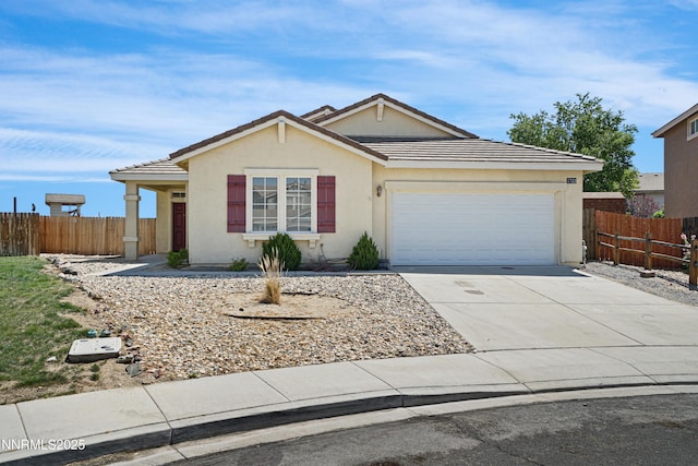 1723 Blue Oak Ct, Fernley, NV 89408 - ranch-style home with a garage, driveway, stucco siding, and a tiled roof