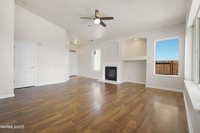 1723 Blue Oak Ct, Fernley, NV 89408 - unfurnished living room featuring ceiling fan, a glass covered fireplace, wood finished floors, and vaulted ceiling