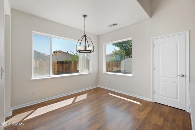 1723 Blue Oak Ct, Fernley, NV 89408 - unfurnished dining area with wood finished floors and a chandelier