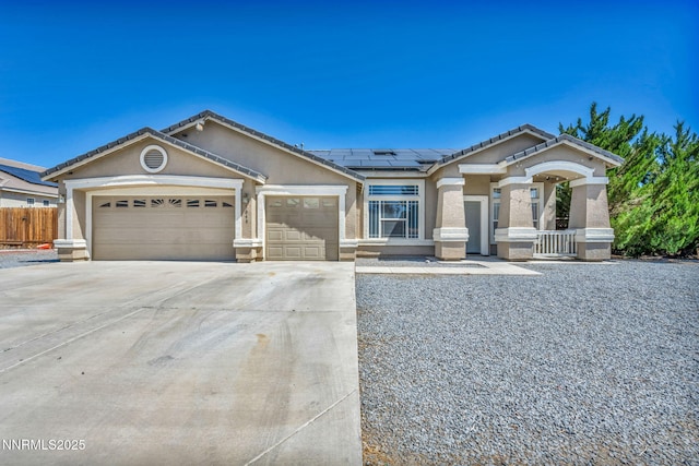 1048 Brierwood Ln, Fernley, NV 89408 - ranch-style house with concrete driveway, solar panels, an attached garage, stucco siding, and a tile roof