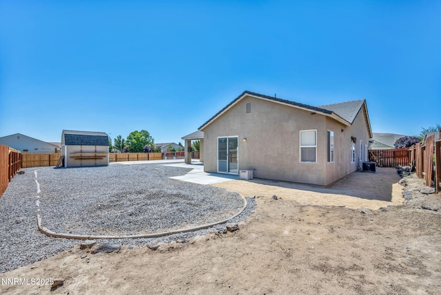 1048 Brierwood Ln, Fernley, NV 89408 - rear view of property with a fenced backyard, stucco siding, a shed, and a patio