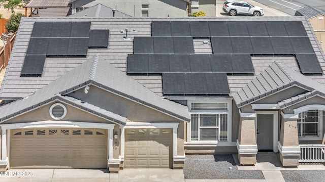 1048 Brierwood Ln, Fernley, NV 89408 - view of front of house with driveway, roof mounted solar panels, and a garage