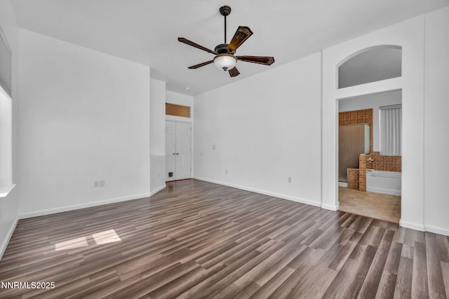 1048 Brierwood Ln, Fernley, NV 89408 - unfurnished bedroom with dark wood finished floors, ensuite bath, and a ceiling fan