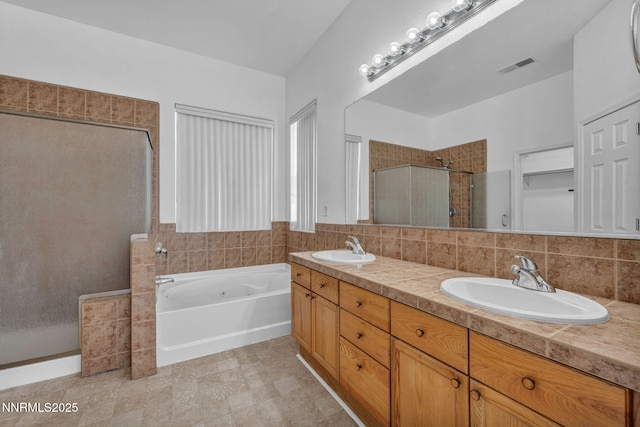 1048 Brierwood Ln, Fernley, NV 89408 - bathroom featuring a shower stall, double vanity, a garden tub, and a closet