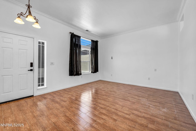 1048 Brierwood Ln, Fernley, NV 89408 - entrance foyer featuring crown molding, wood finished floors, and a chandelier