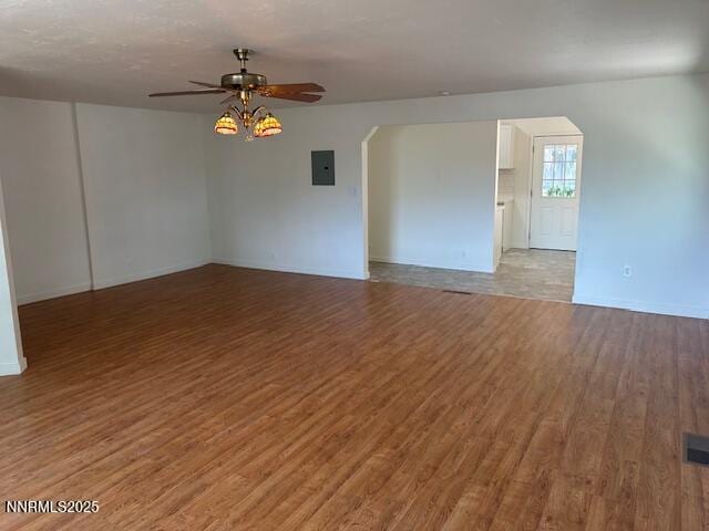 3220 Rice Rd, Fallon, NV 89406 - empty room with arched walkways, a ceiling fan, and light wood-style flooring