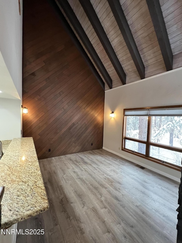 908 Harold Dr Unit 23, Incline Village, NV 89451 - unfurnished living room with high vaulted ceiling, a wood ceiling with exposed beams, wood finished floors, and wood walls