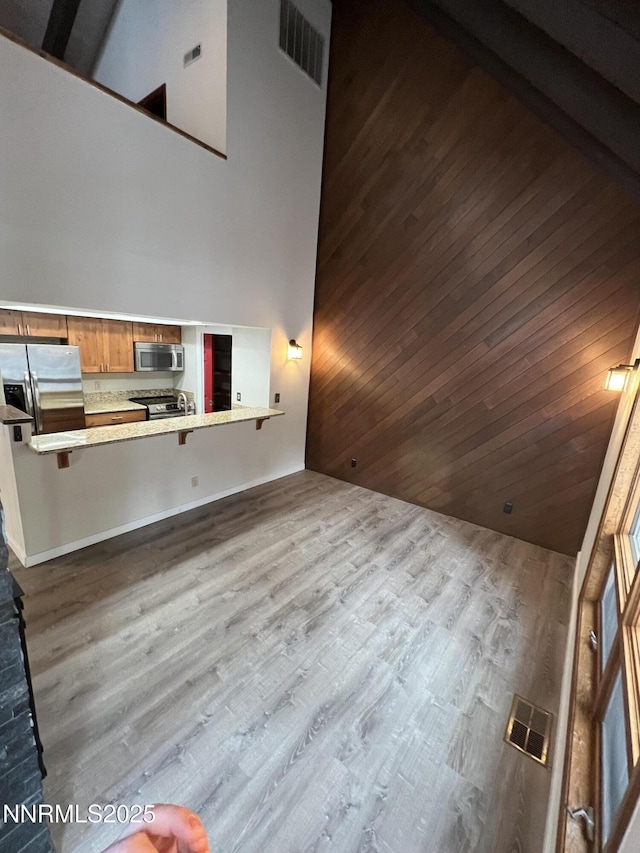 908 Harold Dr Unit 23, Incline Village, NV 89451 - unfurnished living room featuring a high ceiling, wood finished floors, and wood ceiling