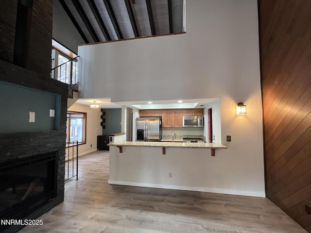 908 Harold Dr Unit 23, Incline Village, NV 89451 - kitchen with appliances with stainless steel finishes, high vaulted ceiling, a peninsula, a breakfast bar, and healthy amount of natural light
