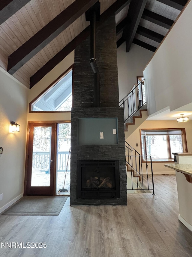 908 Harold Dr Unit 23, Incline Village, NV 89451 - unfurnished living room featuring a wood ceiling with exposed beams, stairs, high vaulted ceiling, wood finished floors, and a fireplace