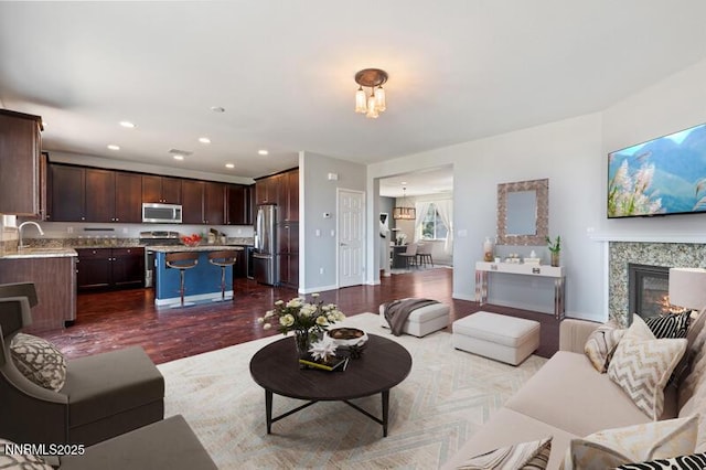 2720 Peavine Pines Ct, Reno, NV 89523 - living room with dark wood-style floors, a premium fireplace, recessed lighting, and a chandelier