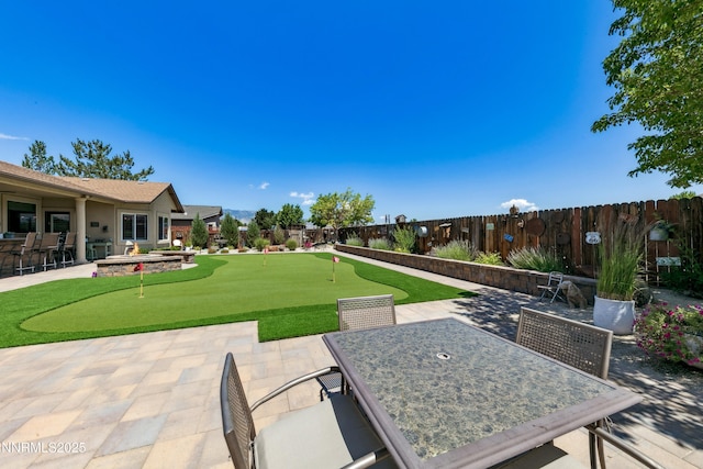 2885 Rio Vis, Minden, NV 89423 - fenced backyard featuring a putting area, a patio area, and outdoor dining area
