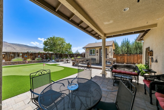 2885 Rio Vis, Minden, NV 89423 - fenced backyard with an area to practice putting, a patio, an outbuilding, a mountain view, and outdoor dining area
