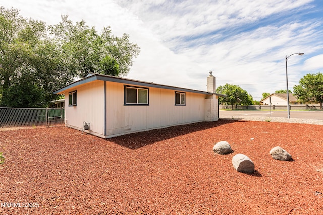 1399 Waterloo Ln, Gardnerville, NV 89410 - view of side of home with a chimney