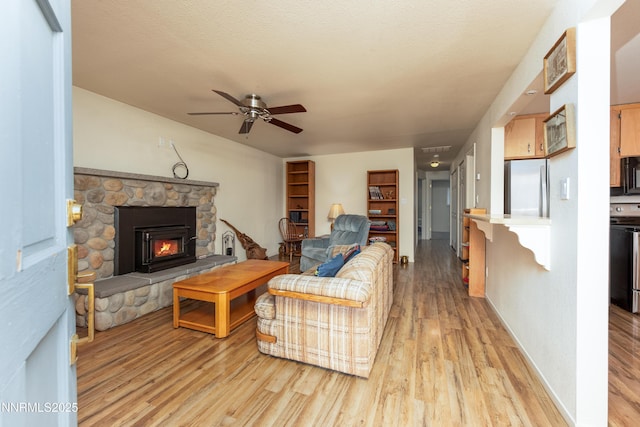 1399 Waterloo Ln, Gardnerville, NV 89410 - living room featuring a ceiling fan, light wood-style floors, and a fireplace