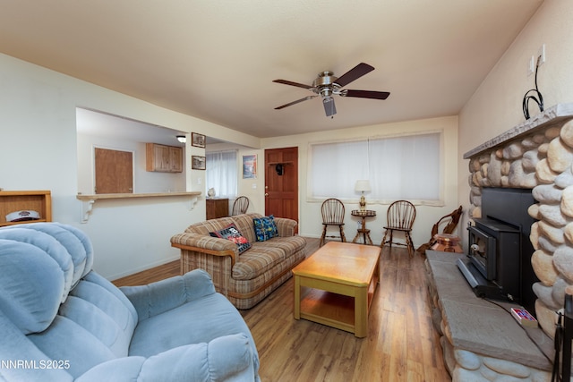 1399 Waterloo Ln, Gardnerville, NV 89410 - living room featuring light wood-style flooring, ceiling fan, and a wood stove