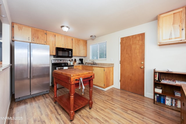1399 Waterloo Ln, Gardnerville, NV 89410 - kitchen with stainless steel appliances, light wood-style flooring, light countertops, and light brown cabinetry