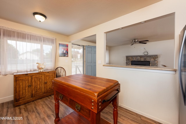 1399 Waterloo Ln, Gardnerville, NV 89410 - dining space with wood finished floors, ceiling fan, and a fireplace