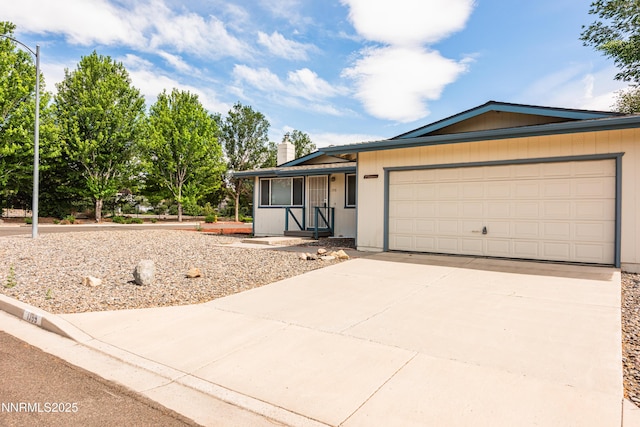 1399 Waterloo Ln, Gardnerville, NV 89410 - single story home with concrete driveway, an attached garage, and a chimney