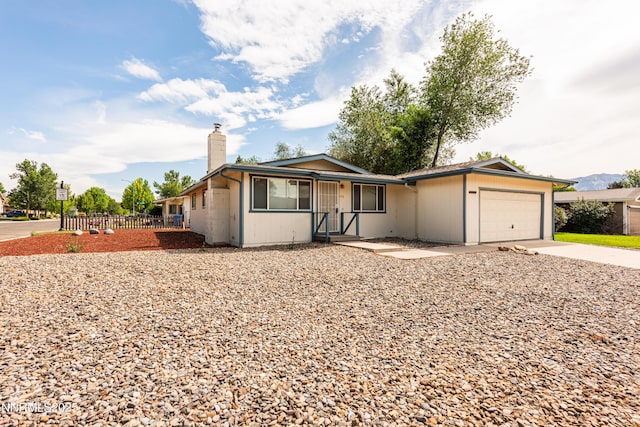 1399 Waterloo Ln, Gardnerville, NV 89410 - ranch-style home with a chimney, driveway, and an attached garage