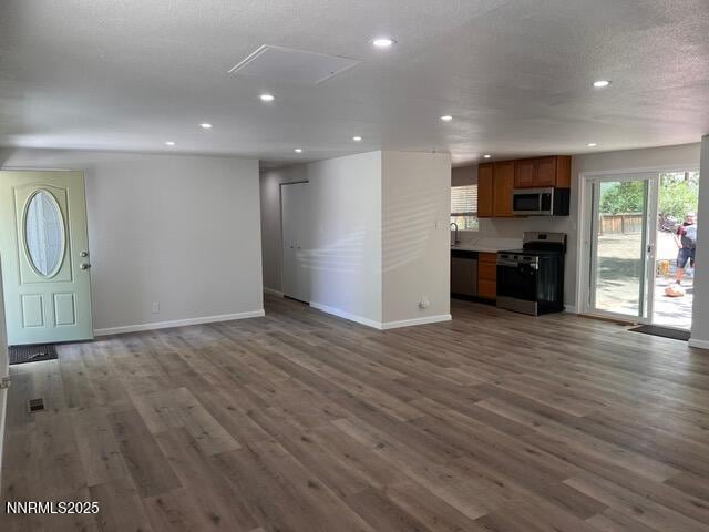 9180 Fremont Way, Reno, NV 89506 - unfurnished living room featuring plenty of natural light, dark wood-style floors, and recessed lighting