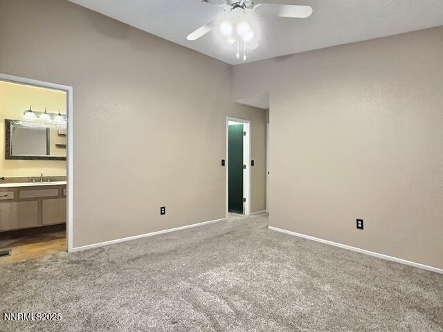 8425 Corrigan Way, Reno, NV 89506 - unfurnished bedroom featuring light colored carpet, ensuite bathroom, and ceiling fan