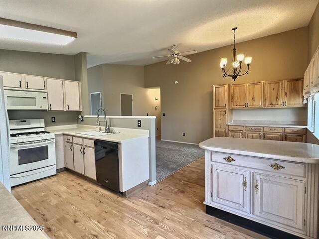 8425 Corrigan Way, Reno, NV 89506 - kitchen featuring white appliances, a peninsula, a ceiling fan, and light countertops