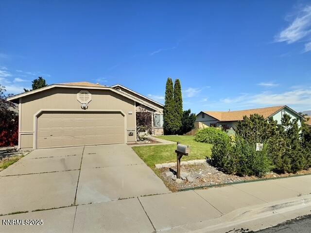 8425 Corrigan Way, Reno, NV 89506 - ranch-style house with concrete driveway, a garage, and a front yard
