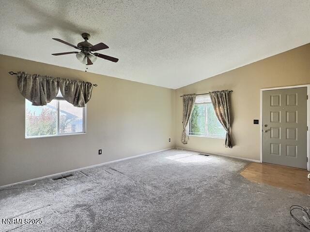 8425 Corrigan Way, Reno, NV 89506 - unfurnished room featuring carpet floors, ceiling fan, a textured ceiling, and lofted ceiling