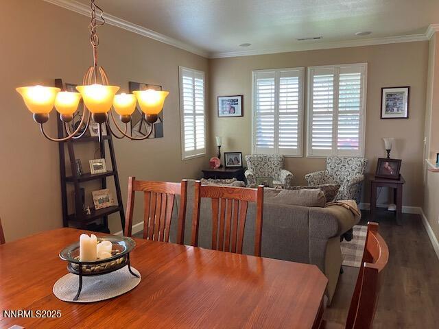 4073 Talladega Dr, Sparks, NV 89436 - dining space with a chandelier, wood finished floors, and crown molding