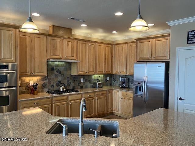 4073 Talladega Dr, Sparks, NV 89436 - kitchen featuring appliances with stainless steel finishes, ornamental molding, light stone counters, tasteful backsplash, and recessed lighting