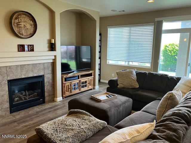 4073 Talladega Dr, Sparks, NV 89436 - living area featuring wood finished floors, plenty of natural light, a fireplace, and recessed lighting