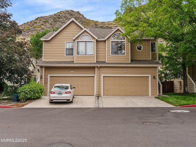 4325 Leeward Ln, Reno, NV 89502 - view of front of property with an attached garage, driveway, a shingled roof, and a mountain view
