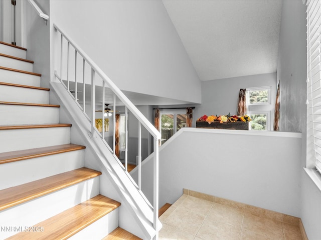4325 Leeward Ln, Reno, NV 89502 - stairway with tile patterned floors, high vaulted ceiling, and ceiling fan