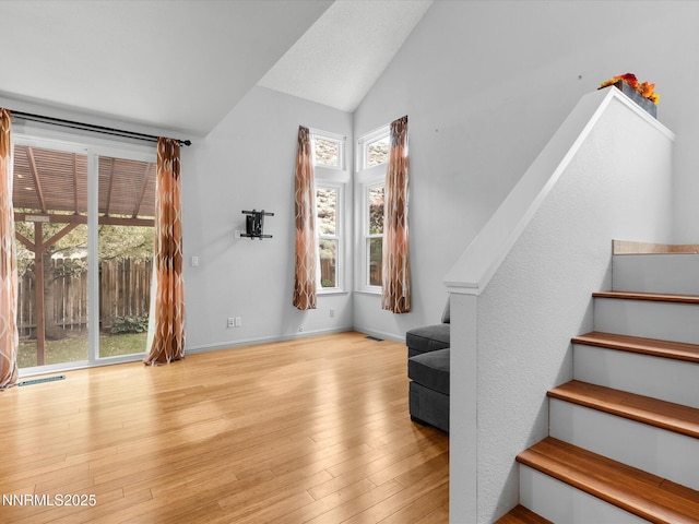4325 Leeward Ln, Reno, NV 89502 - unfurnished living room with stairway, lofted ceiling, and wood finished floors