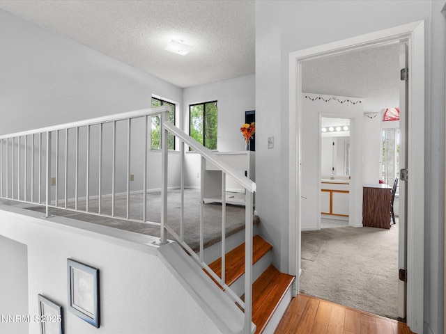 4325 Leeward Ln, Reno, NV 89502 - staircase with a textured ceiling and wood finished floors