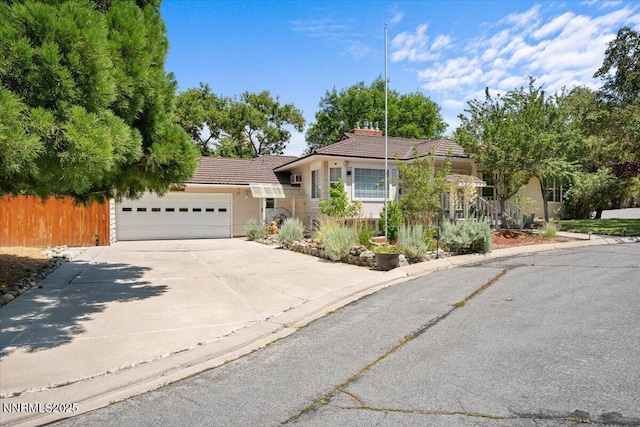 7 Circle Dr, Carson City, NV 89703 - view of front of home featuring a tile roof, an attached garage, concrete driveway, and stucco siding