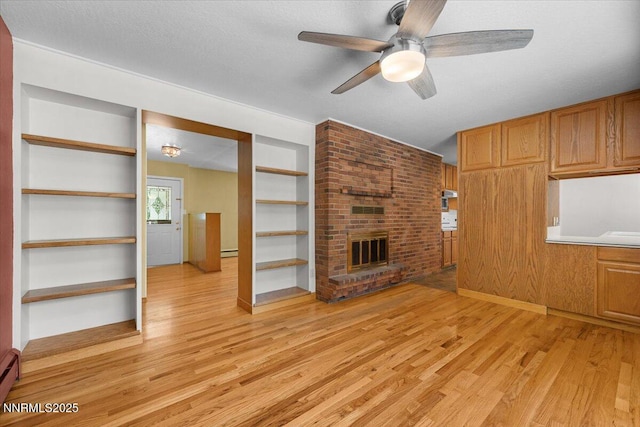 7 Circle Dr, Carson City, NV 89703 - unfurnished living room with light wood finished floors, ceiling fan, a brick fireplace, built in features, and a baseboard radiator