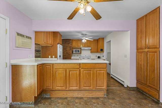 7 Circle Dr, Carson City, NV 89703 - kitchen with a baseboard radiator, ceiling fan, brown cabinets, white appliances, and under cabinet range hood