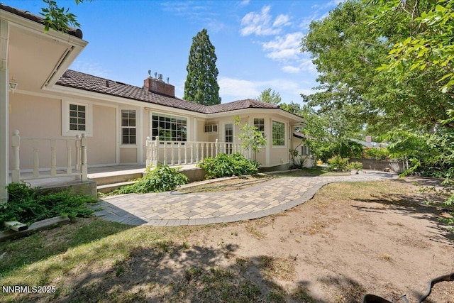 7 Circle Dr, Carson City, NV 89703 - rear view of house with a chimney, a patio, and a tile roof