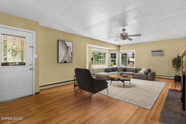 7 Circle Dr, Carson City, NV 89703 - living area with a baseboard radiator, ceiling fan, light wood-type flooring, and an AC wall unit