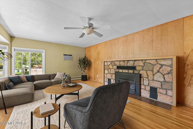 7 Circle Dr, Carson City, NV 89703 - living room featuring wood finished floors, a fireplace, wood walls, ceiling fan, and a wall mounted AC