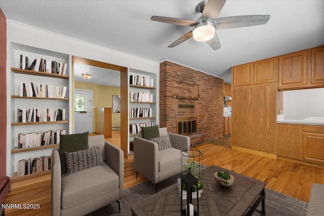 7 Circle Dr, Carson City, NV 89703 - living area with light wood finished floors, a ceiling fan, built in shelves, and a fireplace
