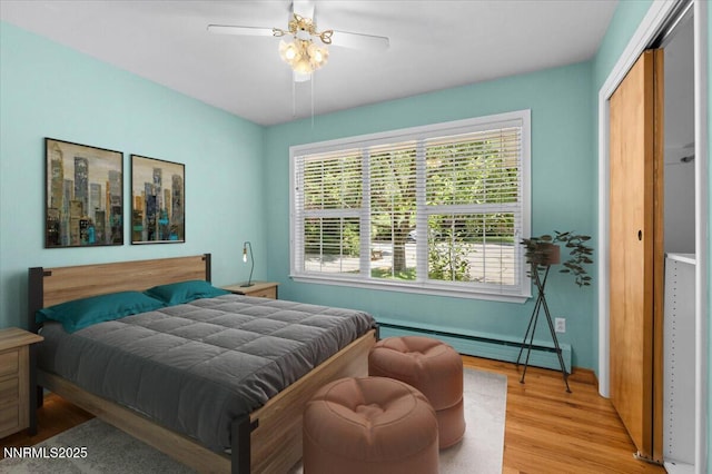 7 Circle Dr, Carson City, NV 89703 - bedroom with a baseboard heating unit, light wood-style flooring, a closet, and ceiling fan
