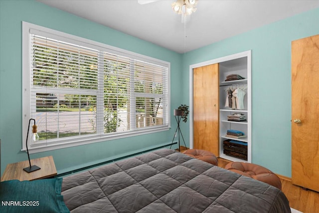 7 Circle Dr, Carson City, NV 89703 - bedroom with multiple windows, wood finished floors, a closet, and ceiling fan