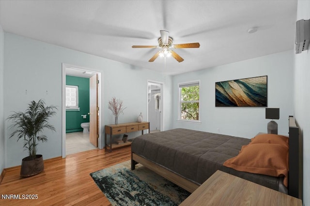 7 Circle Dr, Carson City, NV 89703 - bedroom with light wood finished floors, a spacious closet, ensuite bathroom, ceiling fan, and a closet