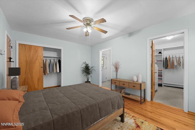 7 Circle Dr, Carson City, NV 89703 - bedroom with a spacious closet, a closet, a baseboard radiator, light wood-type flooring, and ceiling fan