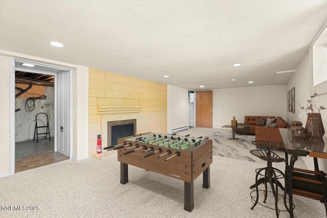 7 Circle Dr, Carson City, NV 89703 - recreation room featuring a baseboard heating unit, carpet, recessed lighting, a textured ceiling, and a fireplace