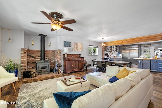 2450 Chukar Dr, Washoe Valley, NV 89704 - living room with dark wood-type flooring, ceiling fan, and a wood stove